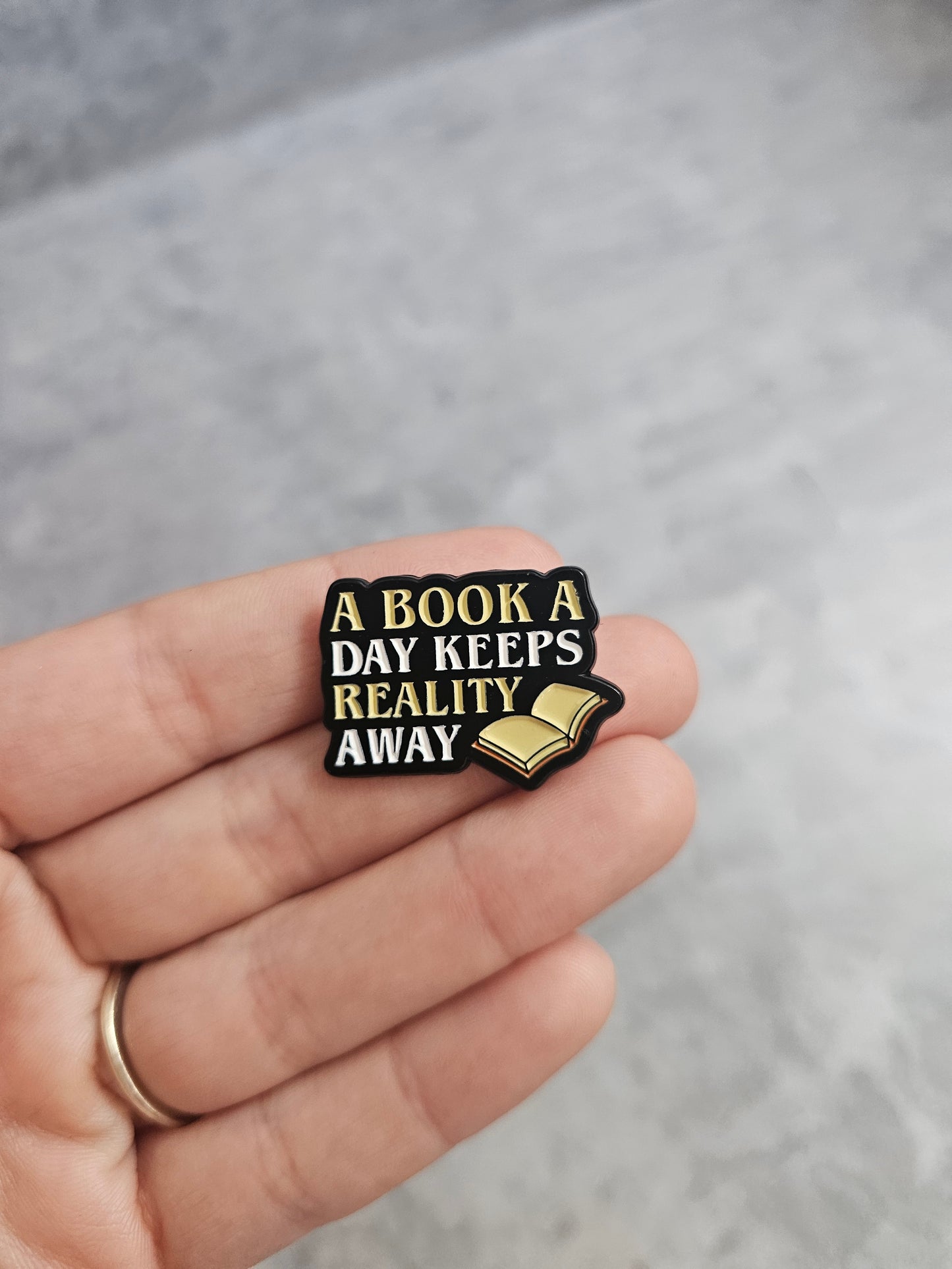 A book a day keeps reality away Pin Badge