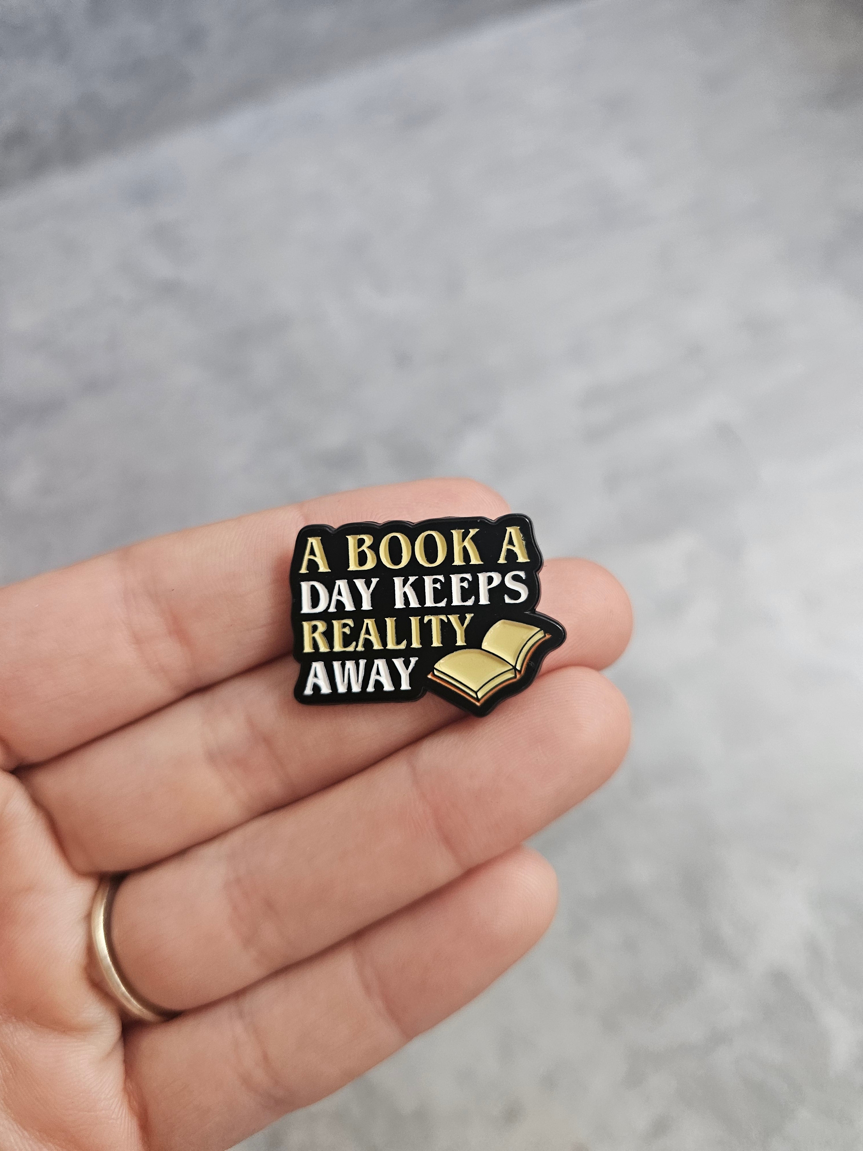 A book a day keeps reality away Pin Badge
