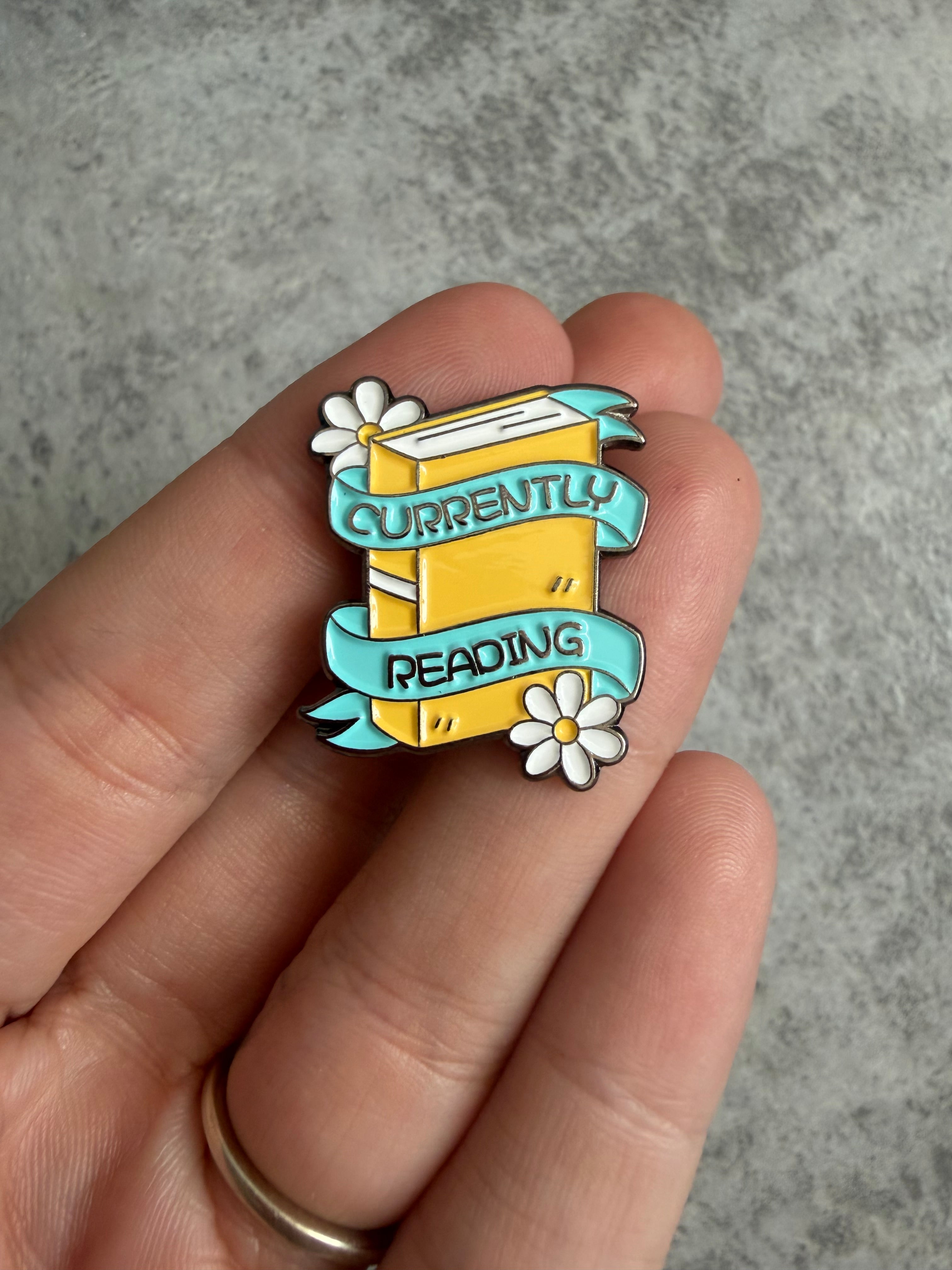 Currently reading yellow book with daisys Pin Badge