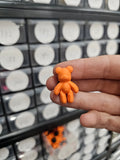 Small orange teddy shoe charm
