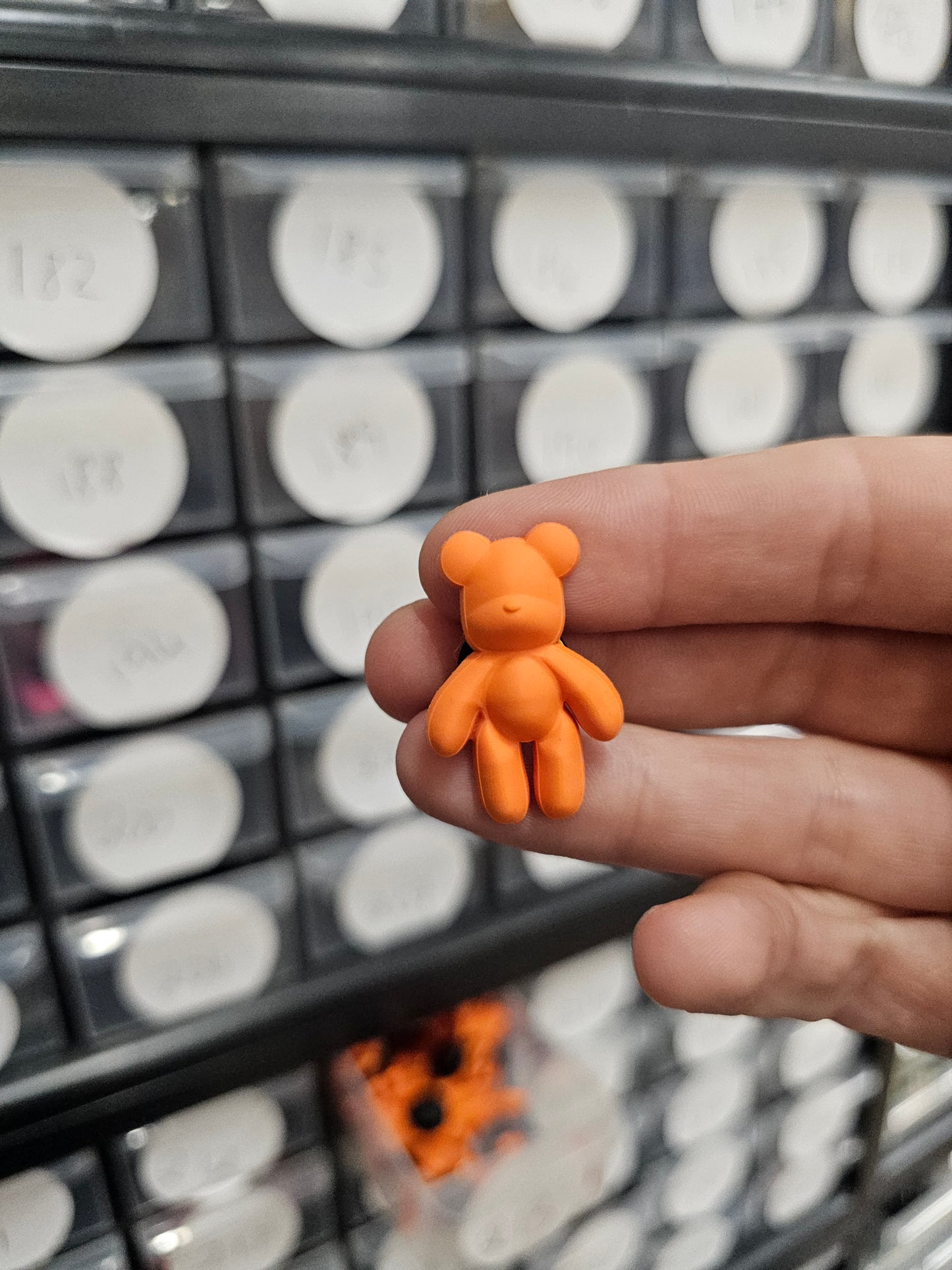 Small orange teddy shoe charm
